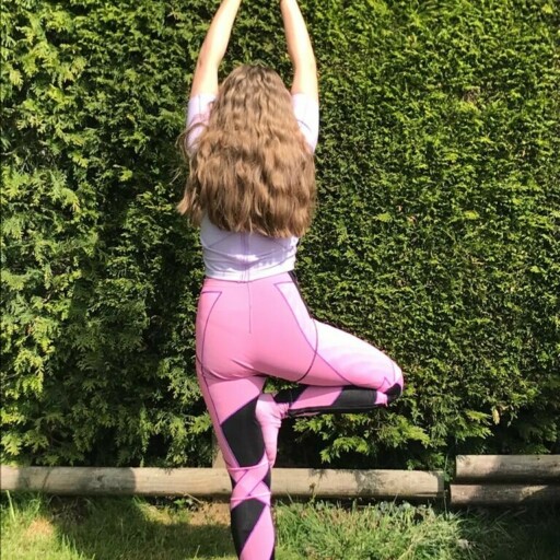 charlotte wearing her orthoses and standing in a yoga style pose